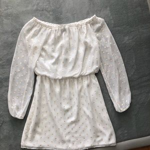 White off the shoulder dress with gold detail.